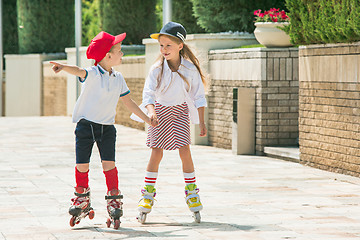 Image showing Portrait of a charming teenage couple roller-skating together