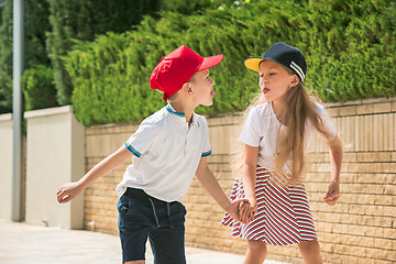 Image showing Portrait of a charming teenage couple roller-skating together