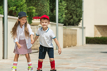 Image showing Portrait of a charming teenage couple roller-skating together