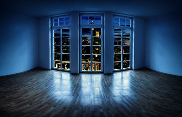 Image showing View from an empty apartment to a city at night