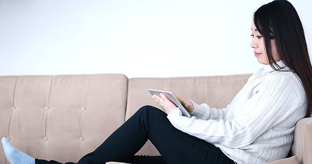 Image showing asian woman using Digital Tablet on sofa