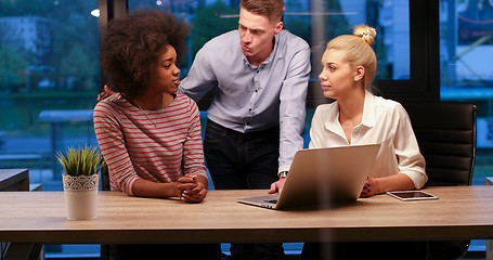 Image showing Multiethnic startup business team in night office