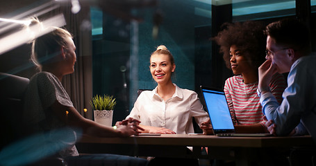 Image showing Multiethnic startup business team in night office