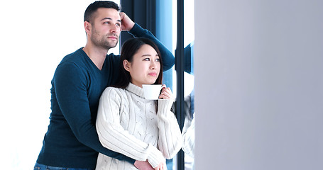 Image showing multiethnic couple relaxing at modern home indoors