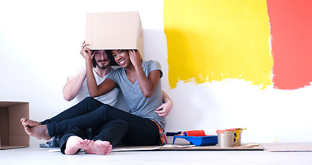 Image showing young multiethnic couple playing with cardboard boxes