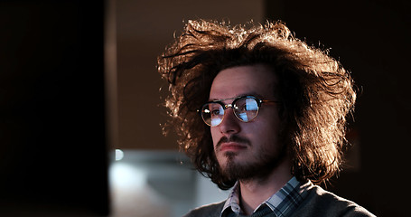 Image showing man working on computer in dark office