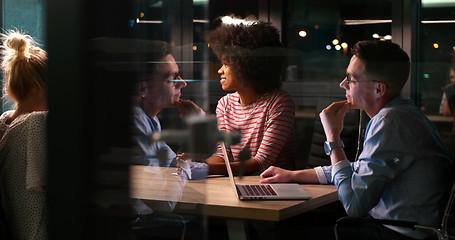 Image showing Multiethnic startup business team in night office