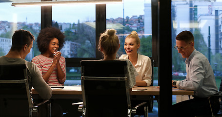 Image showing Multiethnic startup business team in night office