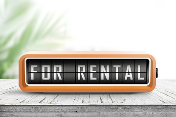 Image showing For rental text on an analog device in orange color