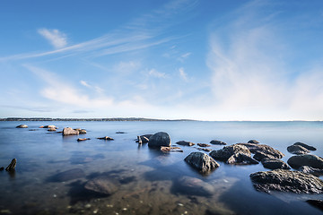 Image showing Rocks by the ocean in the calm water