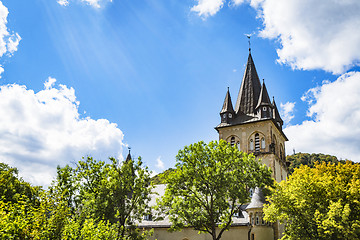 Image showing Castle tower in a forest under a blue sky