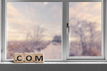 Image showing Com sign in a bright window with a view