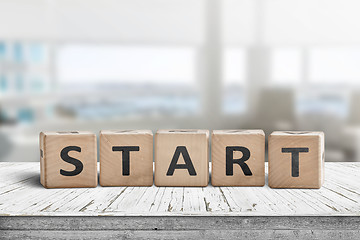 Image showing Start sign in a bright office on a wooden table