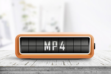 Image showing Mp4 sign on a analog device in a bright living room