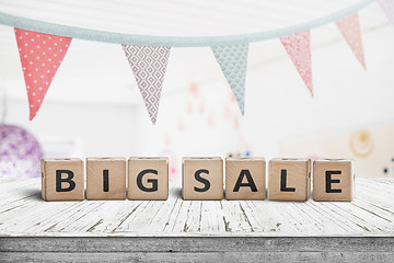 Image showing Big sale sign on a white table with festive flags