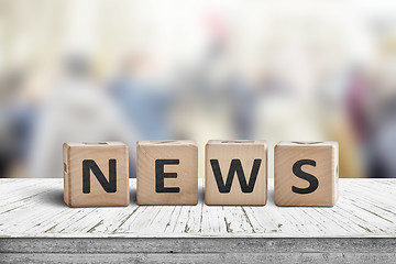 Image showing News sign on a worn wooden table