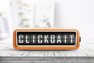 Image showing Clickbait text on a digital device in orange color