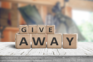 Image showing Give away contest sign on a wooden desk 