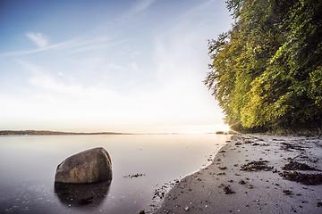 Image showing Rock in the calm water on a nordic beach