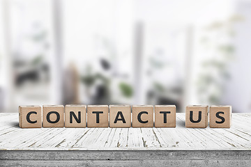 Image showing Contact us sign on a wooden desk