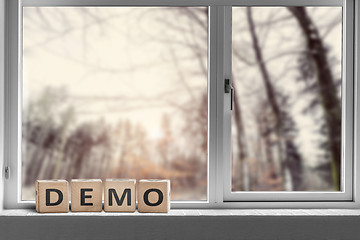 Image showing Demo sign in a window with a view to a forest