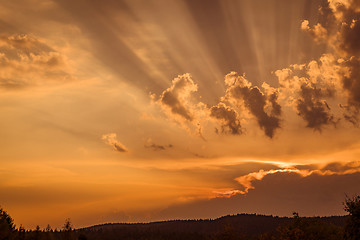 Image showing Sunset with rays lighten up the clouds