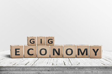 Image showing Gig economy sign made of wood on a worn table