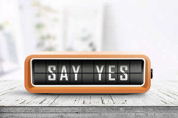 Image showing Say yes message sign on a wooden desk