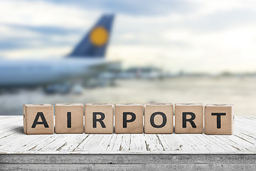 Image showing Airport word sign on a wooden surface with a plane