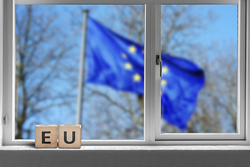 Image showing EU sign in a window with the European union flag
