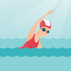 Image showing Young caucasian sportswoman swimming.