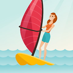 Image showing Young caucasian woman windsurfing in the sea.