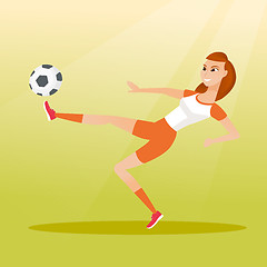 Image showing Young caucasian soccer player kicking a ball.