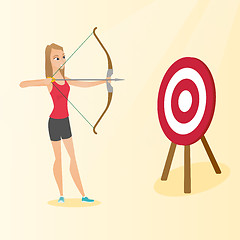Image showing Sportswoman aiming with a bow and arrow at target.