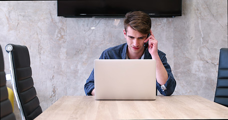 Image showing businessman working using a laptop in startup office