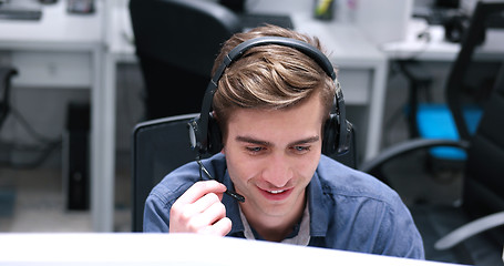 Image showing male call centre operator doing his job