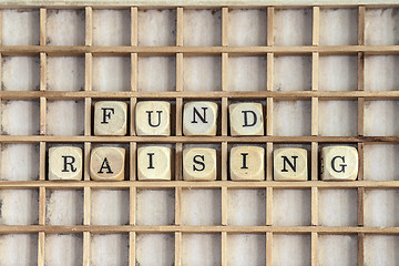 Image showing Fund raising sign made of dices on a dirty shelf