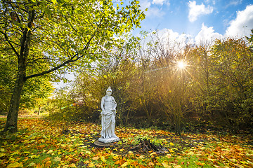 Image showing Sculpture in a park with colorful autumn leaves