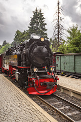 Image showing Locomotive arriving at a train station with trees