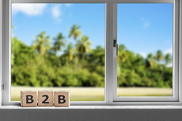 Image showing B2B sign in a window on a tropcal island with palm trees