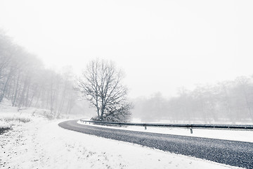 Image showing Curvy highway in a misty winter landscape