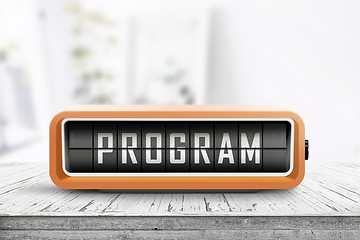 Image showing Program message on a retro clock in orange