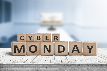 Image showing Cyber monday sign on a wooden desk with a monitor