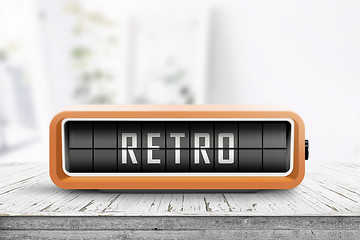 Image showing Retro alarm clock with a message on a wooden table