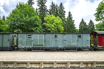 Image showing Train wagon with cargo on a railway at a station