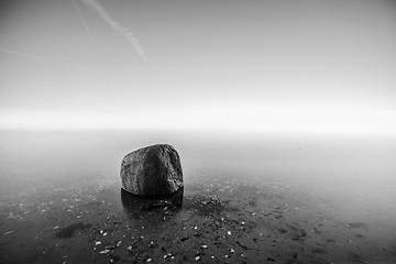 Image showing Single rock in the water by the sea