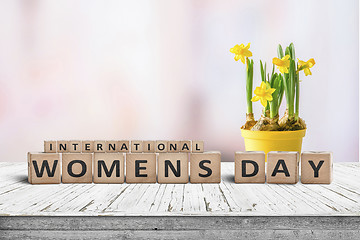 Image showing International Womens day sign with a yellow daffodil flower