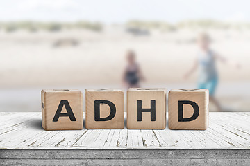 Image showing ADHD sign on a wooden table with kids