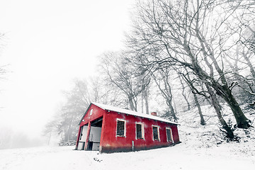 Image showing Red barn in a misty winter landscape 