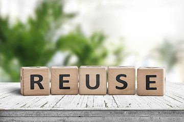 Image showing Reuse sign on a wooden table in a room